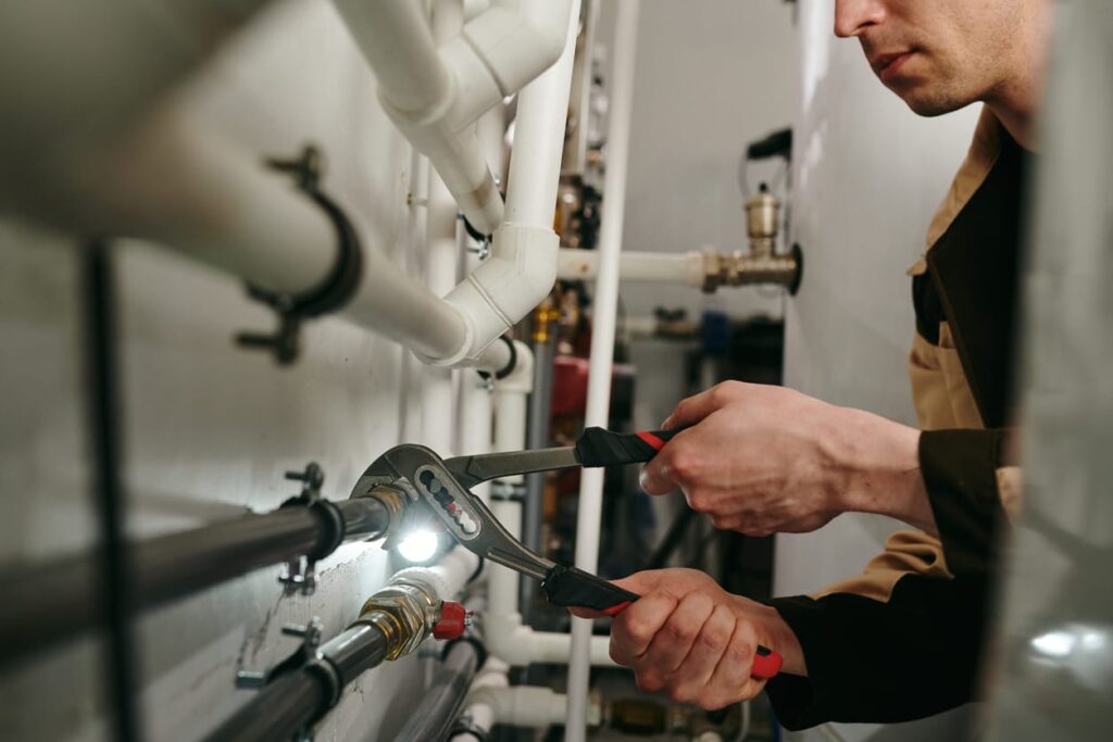 Plumbers maintaining commercial plumbing pipes in Pensacola