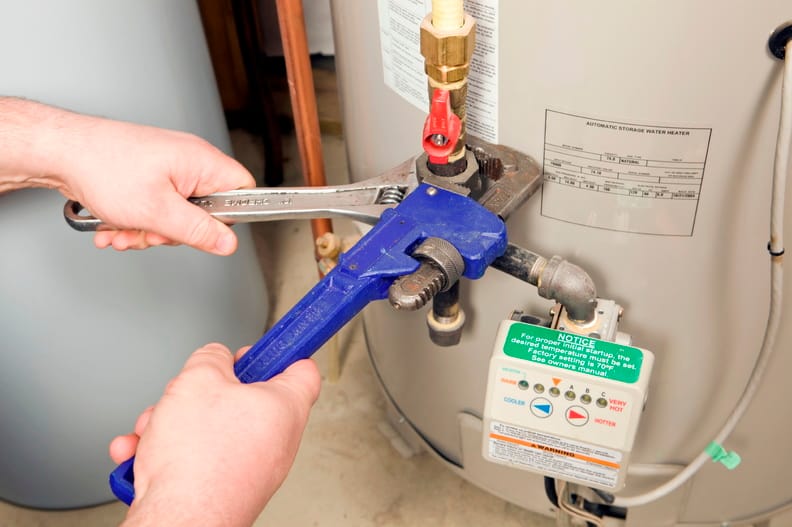 Plumber repairing a water heater valve in Pensacola